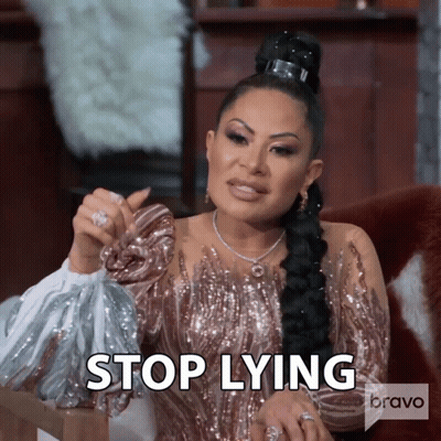 Woman In Sequined Dress Saying Stop Lying Holding Purse GIF