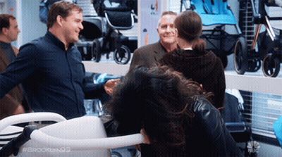 Woman In Sequined Jacket Hugging Woman In White Dress GIF
