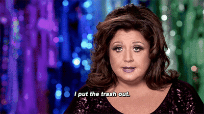 Woman In Sequined Top Saying I Put The Trash Out GIF
