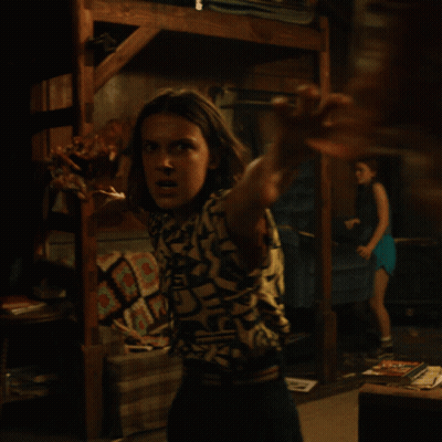 Woman In Shirt Saying A In Dark Room GIF