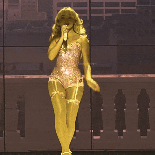 Woman In Short Dress Singing Into Microphone GIF