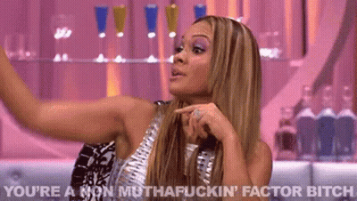 Woman In Silver Dress Making Funny Face Pointing GIF