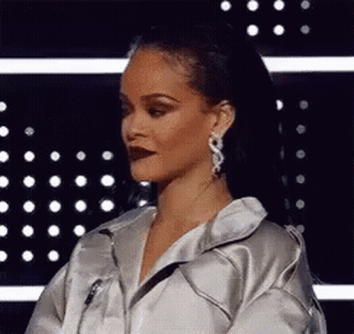 Woman In Silver Jacket And Earrings GIF