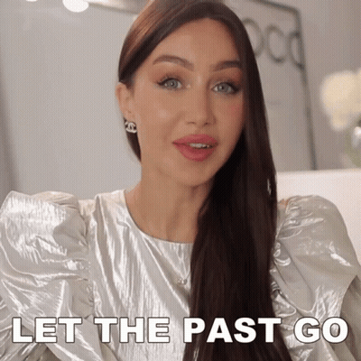 Woman In Silver Top Saying Let The Past Go GIF
