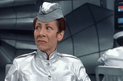 Woman In Silver Uniform Making Silly Face GIF