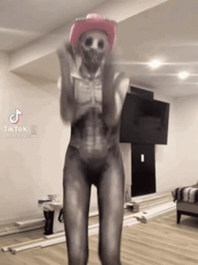 Woman In Skeleton Costume Dancing With Pink Cowboy Hat GIF