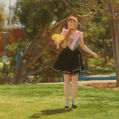 Woman In Skirt Holding Frisbee GIF