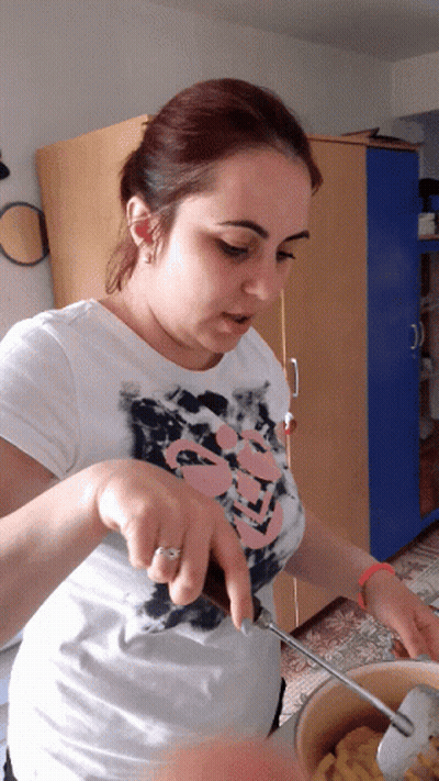 Woman In Skull Shirt Stirring Pot GIF