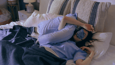 Woman In Sleep Mask Lying In Bed GIF