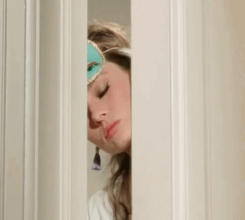 Woman In Sleep Mask Peeking Out Of Door GIF