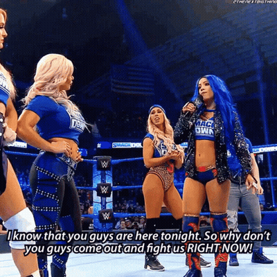 Woman In Smackdown Shirt Talking To Another Woman GIF