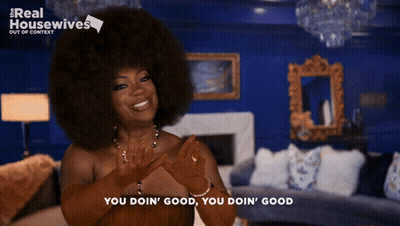 Woman In Snake Print Jacket Hands Folded GIF