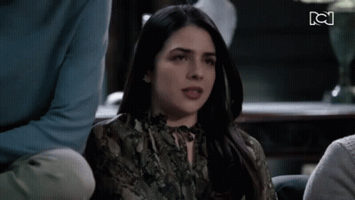 Woman In Snake Print Shirt Sitting With People GIF