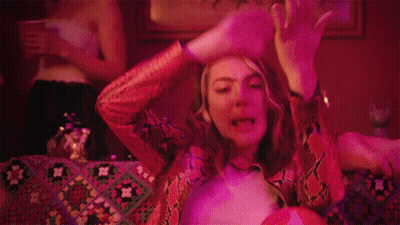 Woman In Snakeskin Jacket Laying On Couch GIF