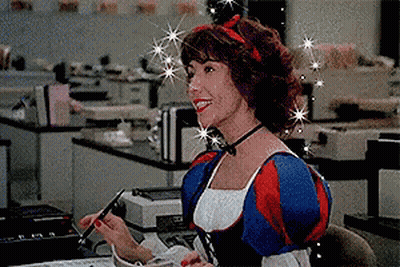 Woman In Snow White Costume Sitting At Desk With Pen GIF