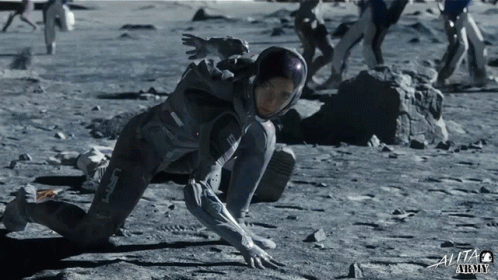 Woman In Space Suit Crawling On Ground With Text Alita Army GIF