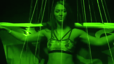Woman In Sports Bra Surrounded By Green Lines GIF