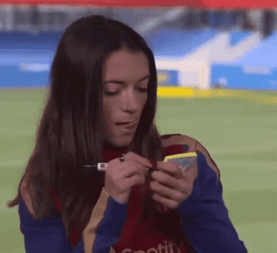 Woman In Spotify Shirt Looking At Cell Phone GIF