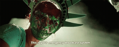 Woman In Statue Of Liberty Mask Says This Is Your Emergency Broadcast System GIF