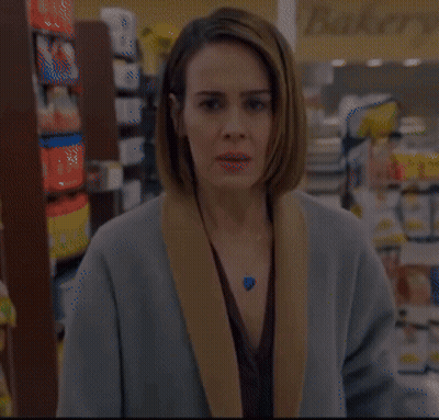 Woman In Store With Fields Sign GIF