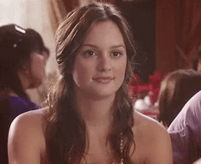 Woman In Strapless Dress Smiling At Table GIF