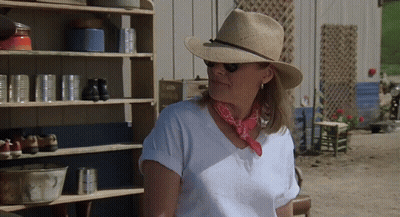 Woman In Straw Hat And Bandana By Shelf GIF