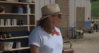 Woman In Straw Hat And Sunglasses Near Shelf Of Cans GIF