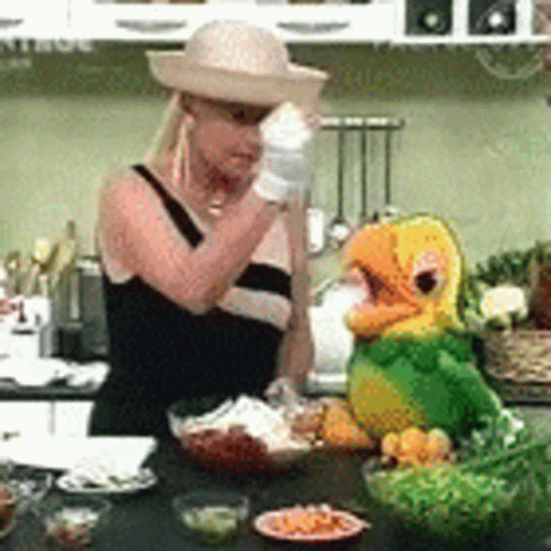 Woman In Straw Hat Next To Stuffed Parrot GIF