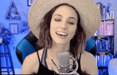 Woman In Straw Hat Talking Into Microphone GIF