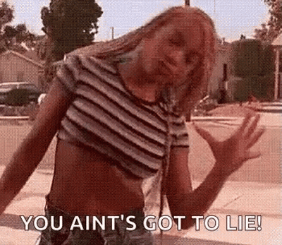 Woman In Striped Crop Top Arms Outstretched On Sidewalk GIF