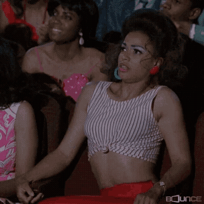 Woman In Striped Crop Top Sitting In Theatre GIF
