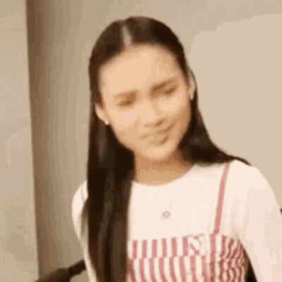 Woman In Striped Dress Making Funny Face GIF