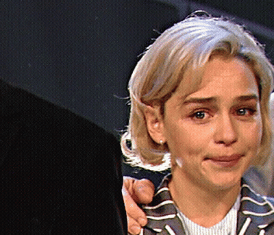 Woman In Striped Jacket Held By Man GIF