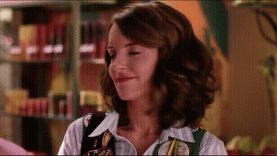 Woman In Striped Shirt And Green Vest Saying Texas GIF