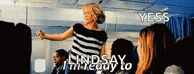 Woman In Striped Shirt Dancing On Airplane GIF