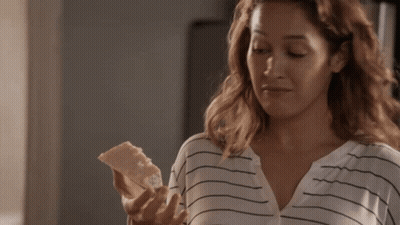 Woman In Striped Shirt Holding Bread GIF