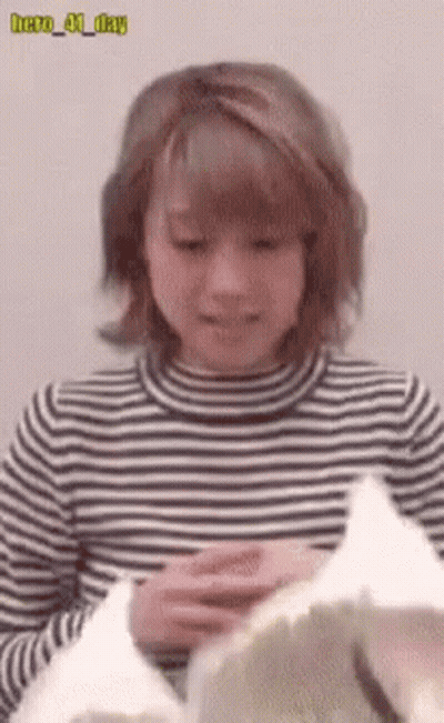 Woman In Striped Shirt Holding Hero 41 Day Paper GIF