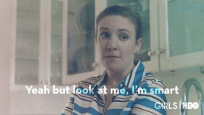 Woman In Striped Shirt Sitting In Kitchen GIF
