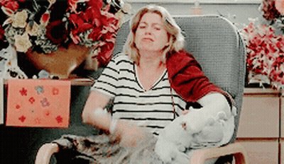 Woman In Striped Shirt Sitting With Stuffed Animal GIF