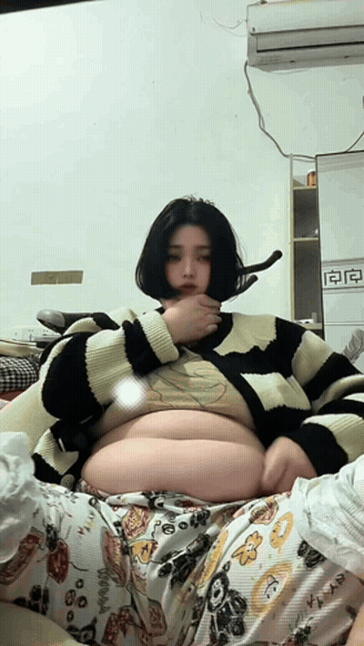 Woman In Striped Sweater Laying On Bed GIF