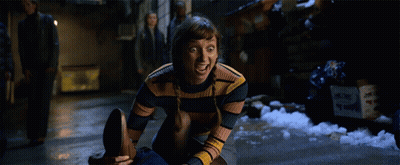 Woman In Striped Sweater Sitting With Mouth Open GIF