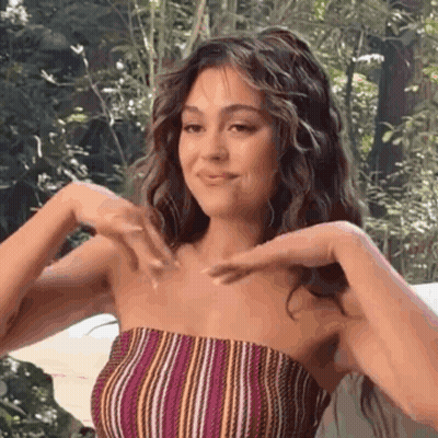 Woman In Striped Top Making Heart Shape GIF