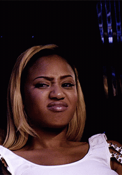 Woman In Studded Tank Top Making Funny Face GIF