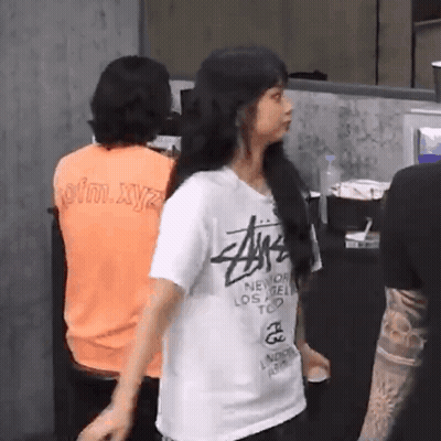 Woman In Stussy T-Shirt Standing In Front Of Group GIF