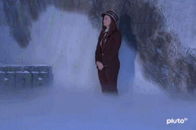 Woman In Suit And Hat In Cave GIF