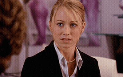 Woman in Suit and Pearls Looking