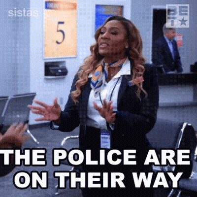 Woman In Suit And Scarf Talking At Airport GIF