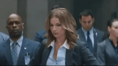 Woman In Suit And Striped Shirt Facing Suits GIF