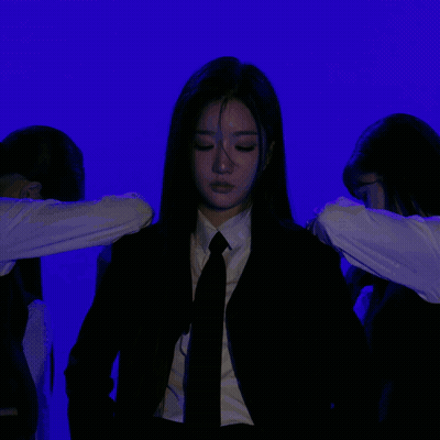 Woman In Suit And Tie Against Purple Wall GIF