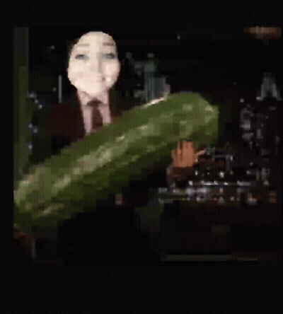 Woman in Suit and Tie Holding Large Cucumber